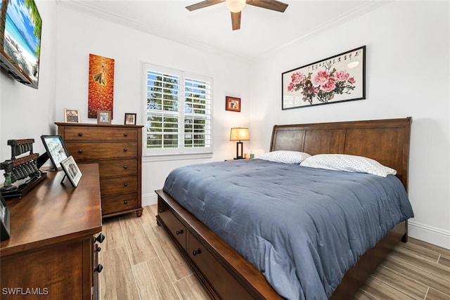 bedroom with ceiling fan, light hardwood / wood-style floors, and ornamental molding