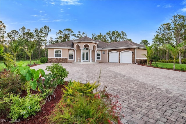 mediterranean / spanish-style home featuring french doors and a garage