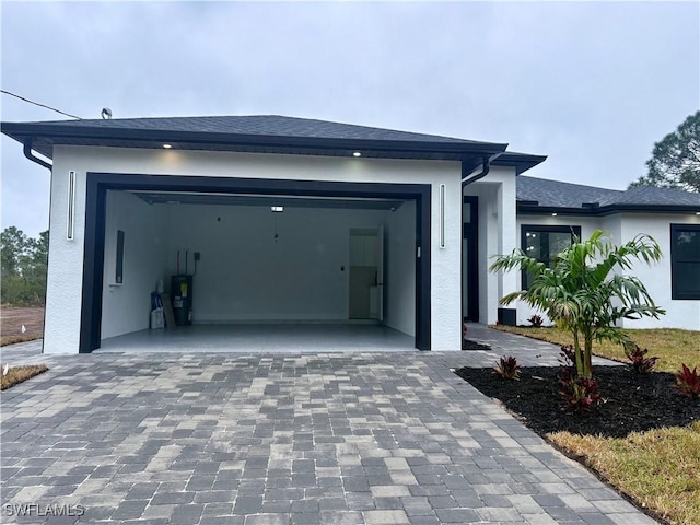 exterior space with water heater and a garage