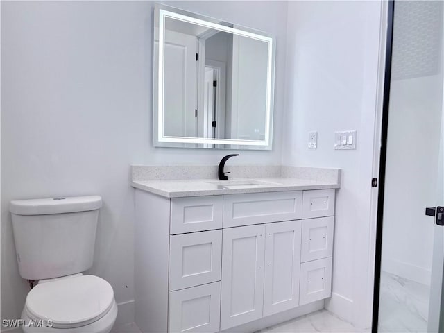 bathroom featuring vanity and toilet