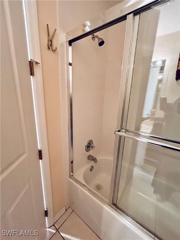 bathroom featuring tile patterned flooring and enclosed tub / shower combo