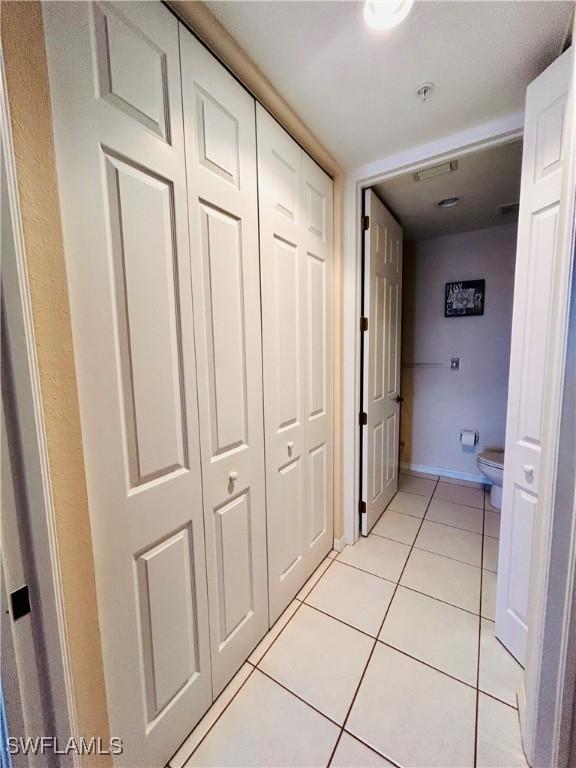 hall with light tile patterned flooring