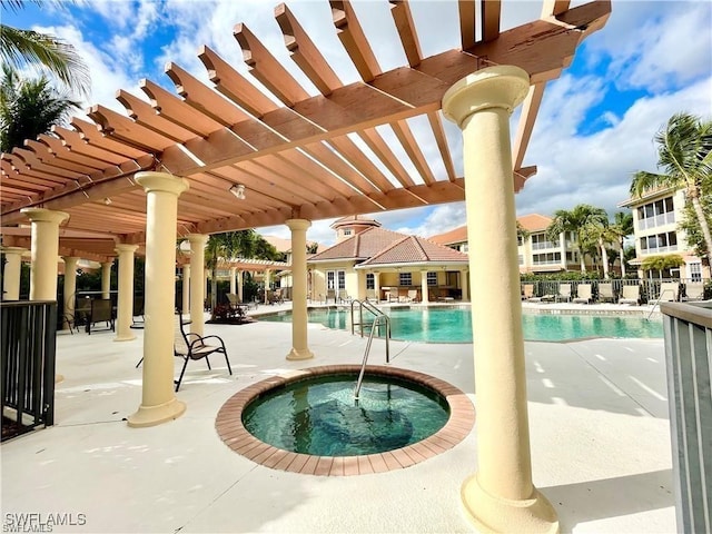 view of swimming pool with a pergola, a patio area, and a hot tub