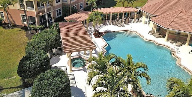 view of swimming pool featuring a community hot tub and a patio