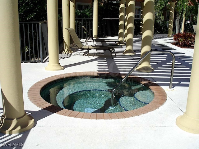 view of swimming pool featuring a community hot tub