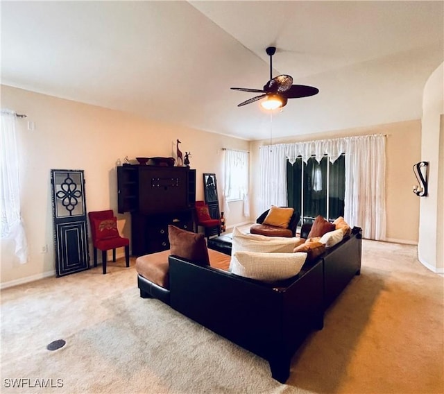 carpeted living room with ceiling fan