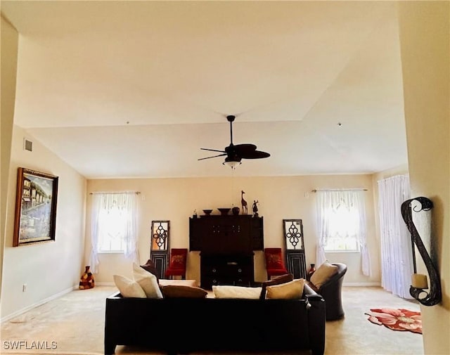 carpeted living room with ceiling fan, a wealth of natural light, and vaulted ceiling