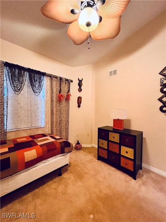 carpeted bedroom featuring ceiling fan