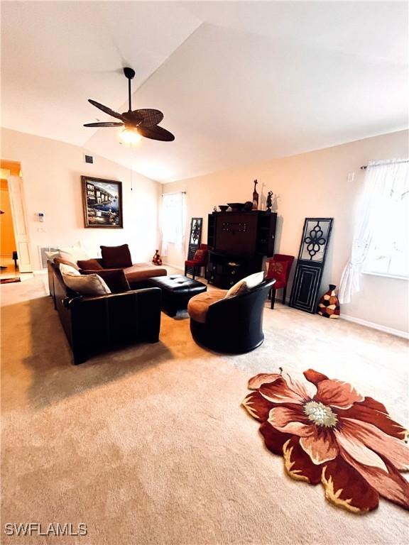 living room featuring ceiling fan, carpet, and vaulted ceiling