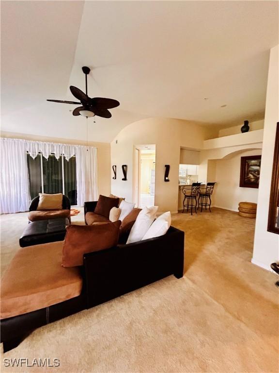 living room with carpet and ceiling fan