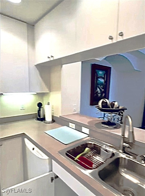 kitchen featuring sink and white cabinets