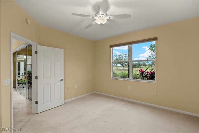 carpeted empty room featuring ceiling fan