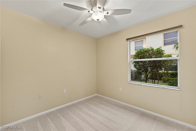 carpeted spare room with ceiling fan and a healthy amount of sunlight