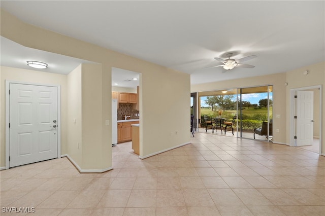 tiled spare room with ceiling fan