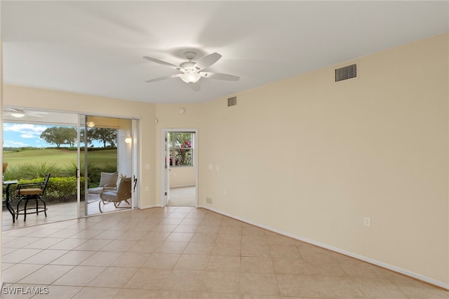 unfurnished room featuring ceiling fan and light tile patterned flooring