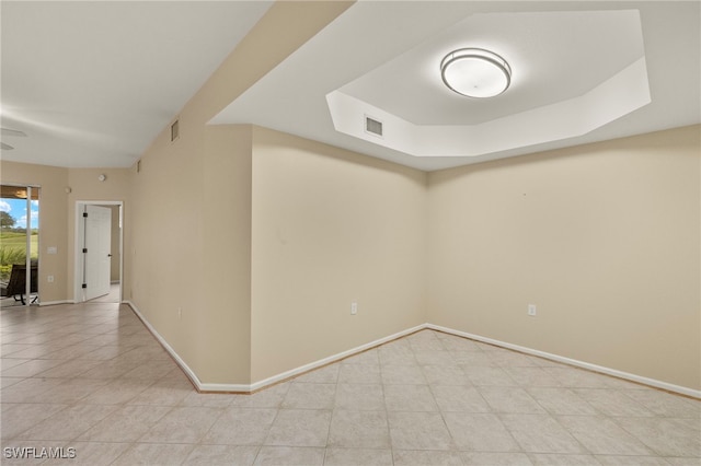 empty room with a raised ceiling