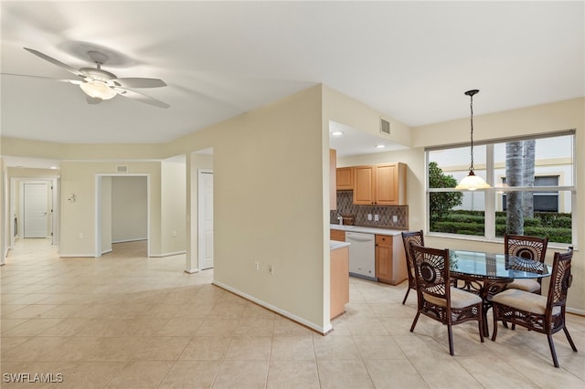 interior space with ceiling fan, dishwasher, backsplash, decorative light fixtures, and light tile patterned floors