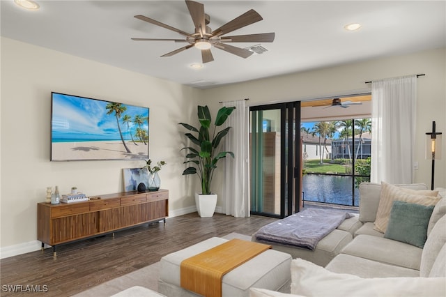 living room with a water view and dark wood-type flooring