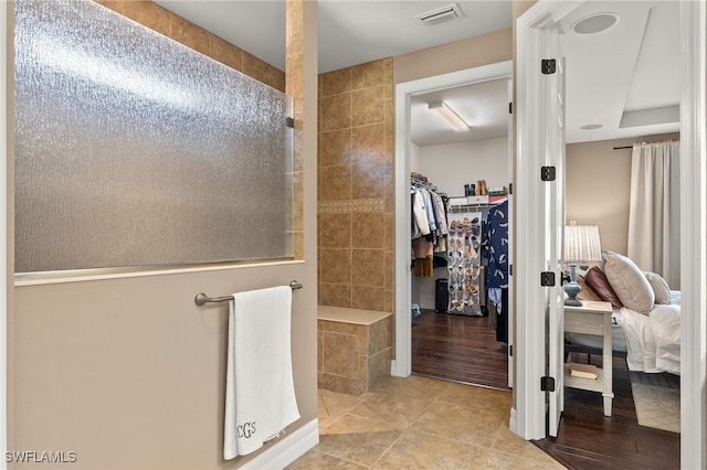 bathroom with tile patterned flooring and a shower