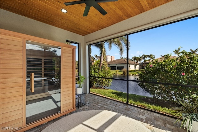 unfurnished sunroom featuring a water view and wood ceiling