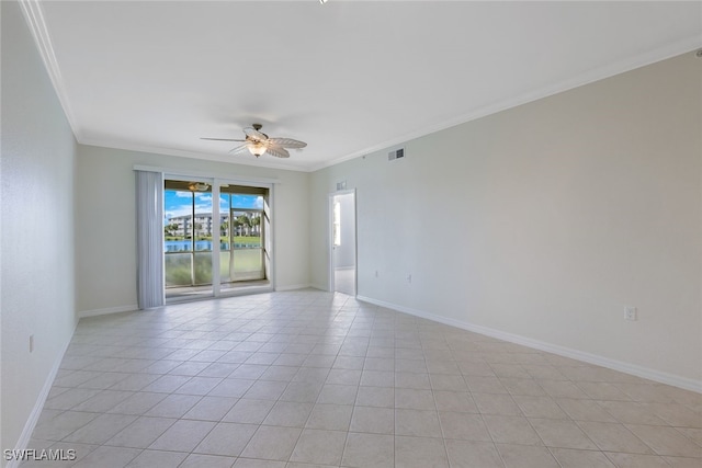 tiled empty room with ceiling fan and crown molding