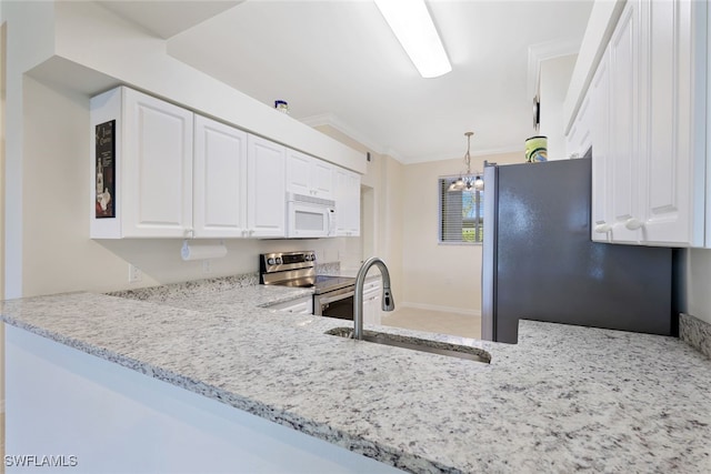 kitchen with white cabinetry, sink, stainless steel appliances, light stone counters, and a chandelier