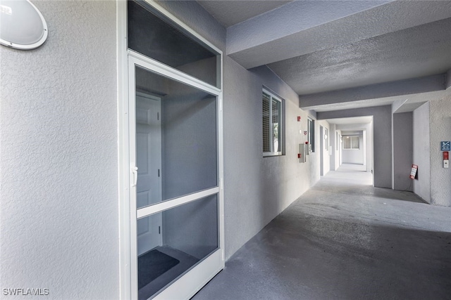 hallway with a textured ceiling