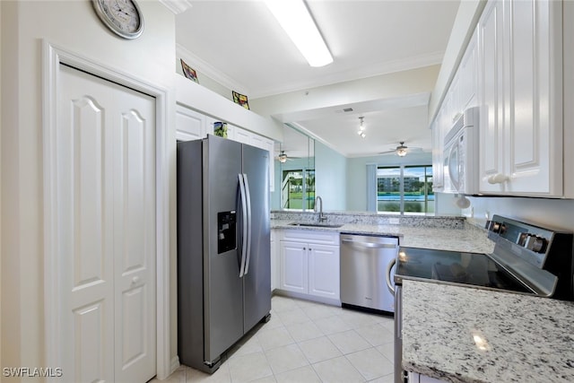 kitchen with white cabinets, appliances with stainless steel finishes, crown molding, and sink