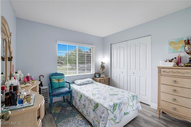 bedroom featuring light wood-type flooring and a closet