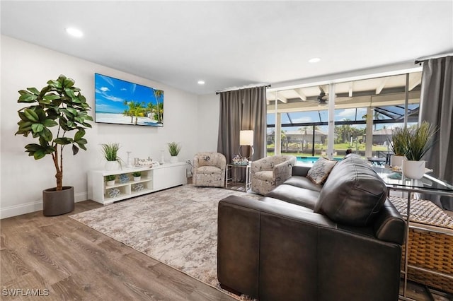 living room featuring ceiling fan and hardwood / wood-style flooring