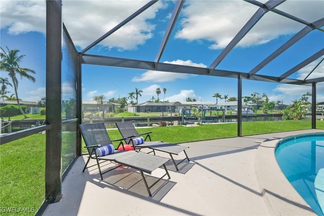 view of pool with a patio area, a water view, and glass enclosure