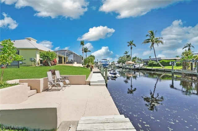 dock area with a lawn and a water view