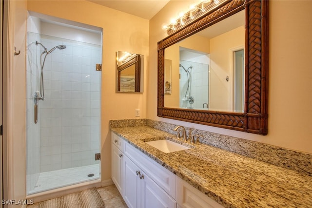 bathroom featuring tile patterned floors, vanity, and walk in shower