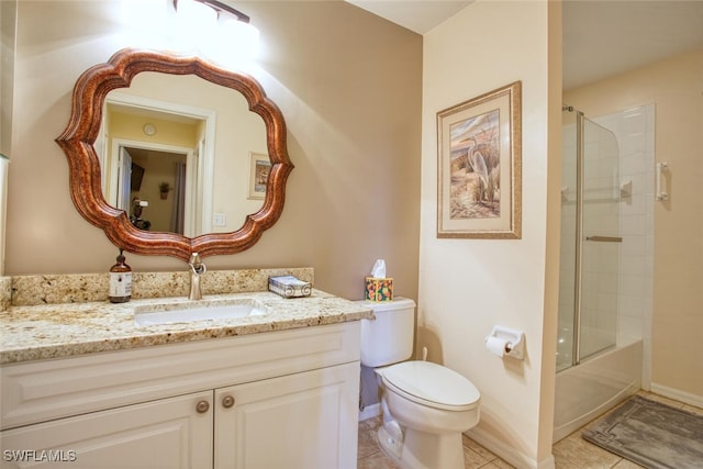 full bathroom featuring tile patterned floors, vanity, toilet, and bath / shower combo with glass door