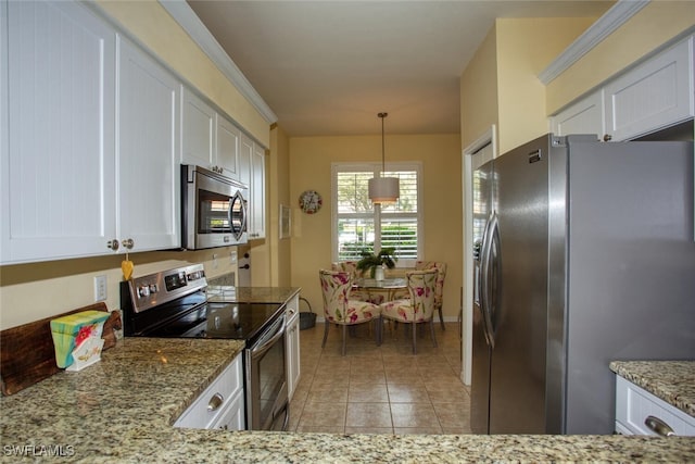 kitchen with light stone countertops, appliances with stainless steel finishes, light tile patterned floors, decorative light fixtures, and white cabinets