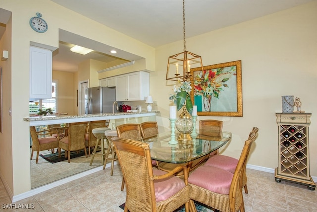 tiled dining room with a notable chandelier