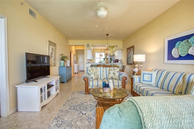 tiled living room featuring ceiling fan