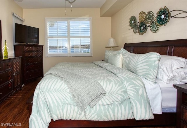 bedroom with dark hardwood / wood-style flooring