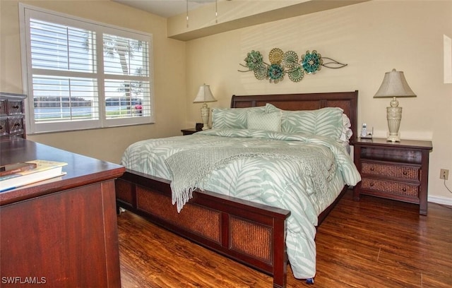 bedroom with dark wood-type flooring