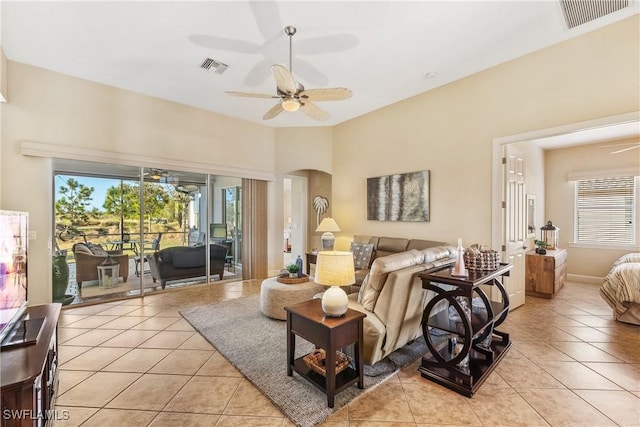 living room with ceiling fan and light tile patterned flooring