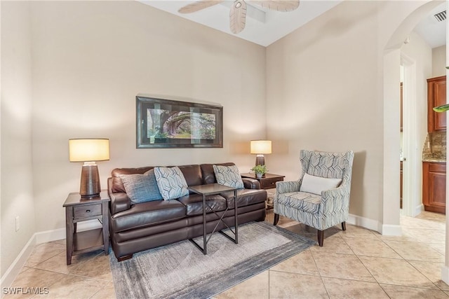 tiled living room featuring ceiling fan