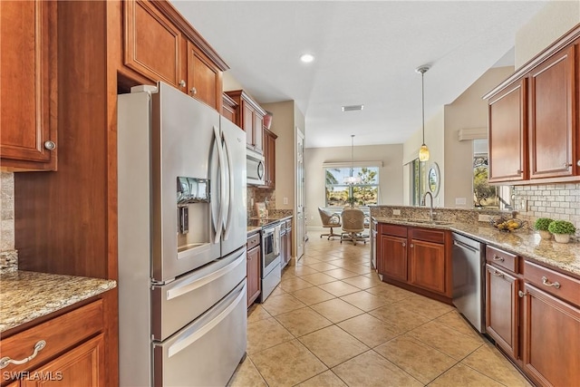 kitchen featuring tasteful backsplash, stainless steel appliances, sink, light tile patterned floors, and hanging light fixtures