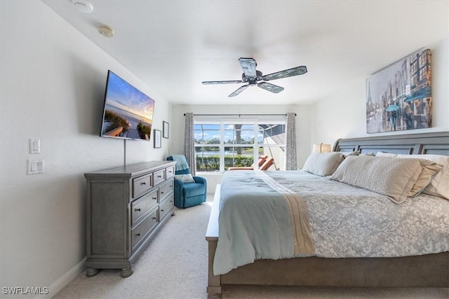 bedroom featuring ceiling fan and light colored carpet