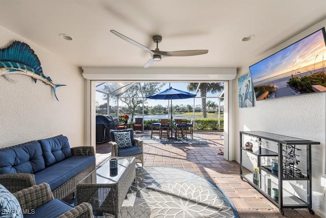 view of patio / terrace with an outdoor hangout area, ceiling fan, and a lanai