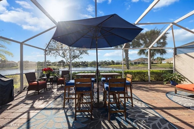 view of patio / terrace with an outdoor bar, a water view, and glass enclosure