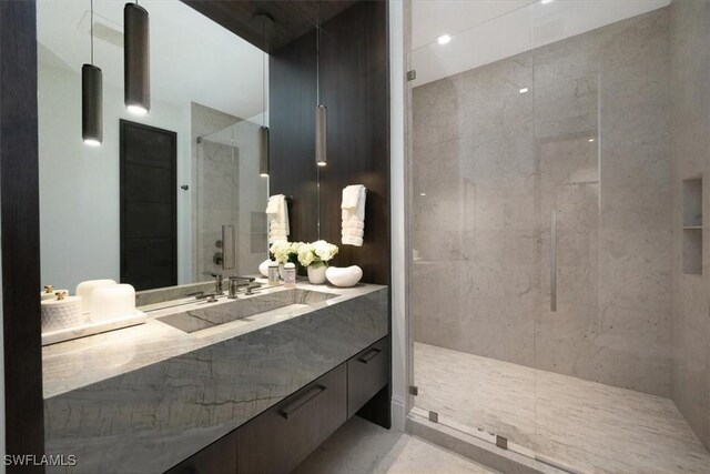 bathroom featuring walk in shower and vanity