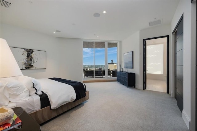 carpeted bedroom featuring access to exterior, connected bathroom, and expansive windows