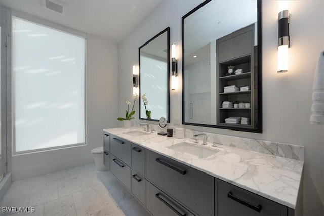 bathroom featuring toilet and vanity