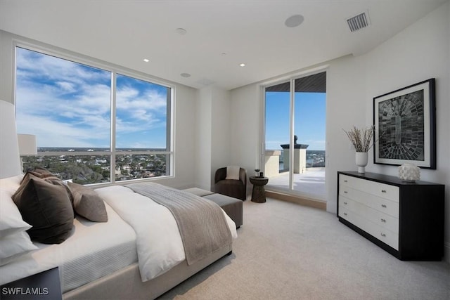 bedroom featuring access to outside, light colored carpet, and a wall of windows