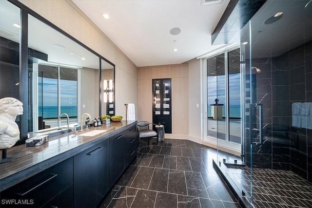 bathroom with walk in shower, vanity, and a water view